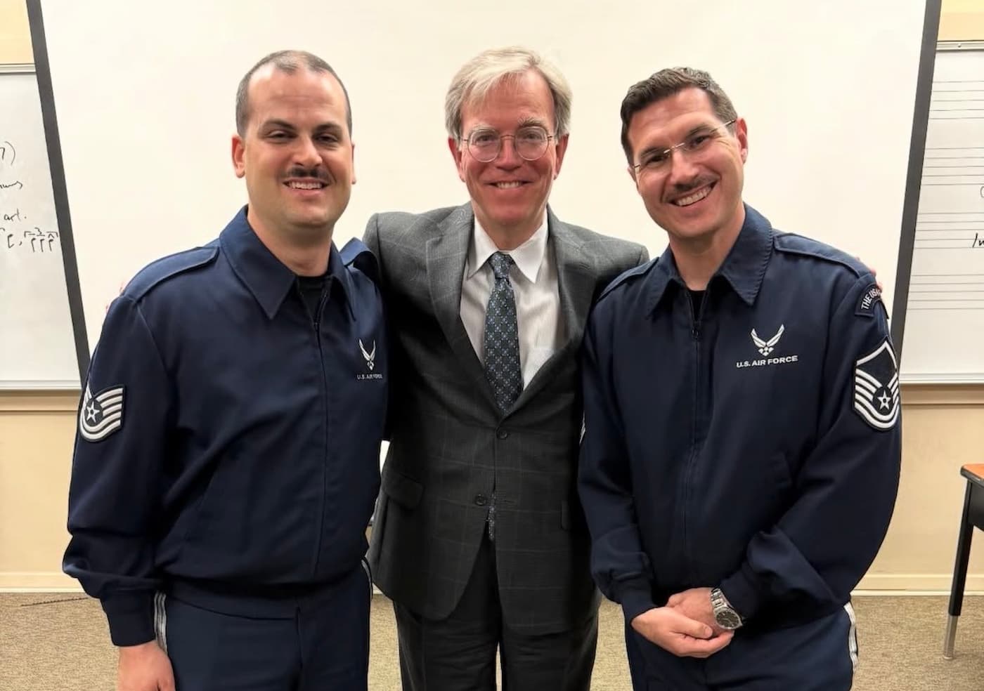 UNT Alum and United States Air Force Band members pose for a photo with Dr. Eric Nestler