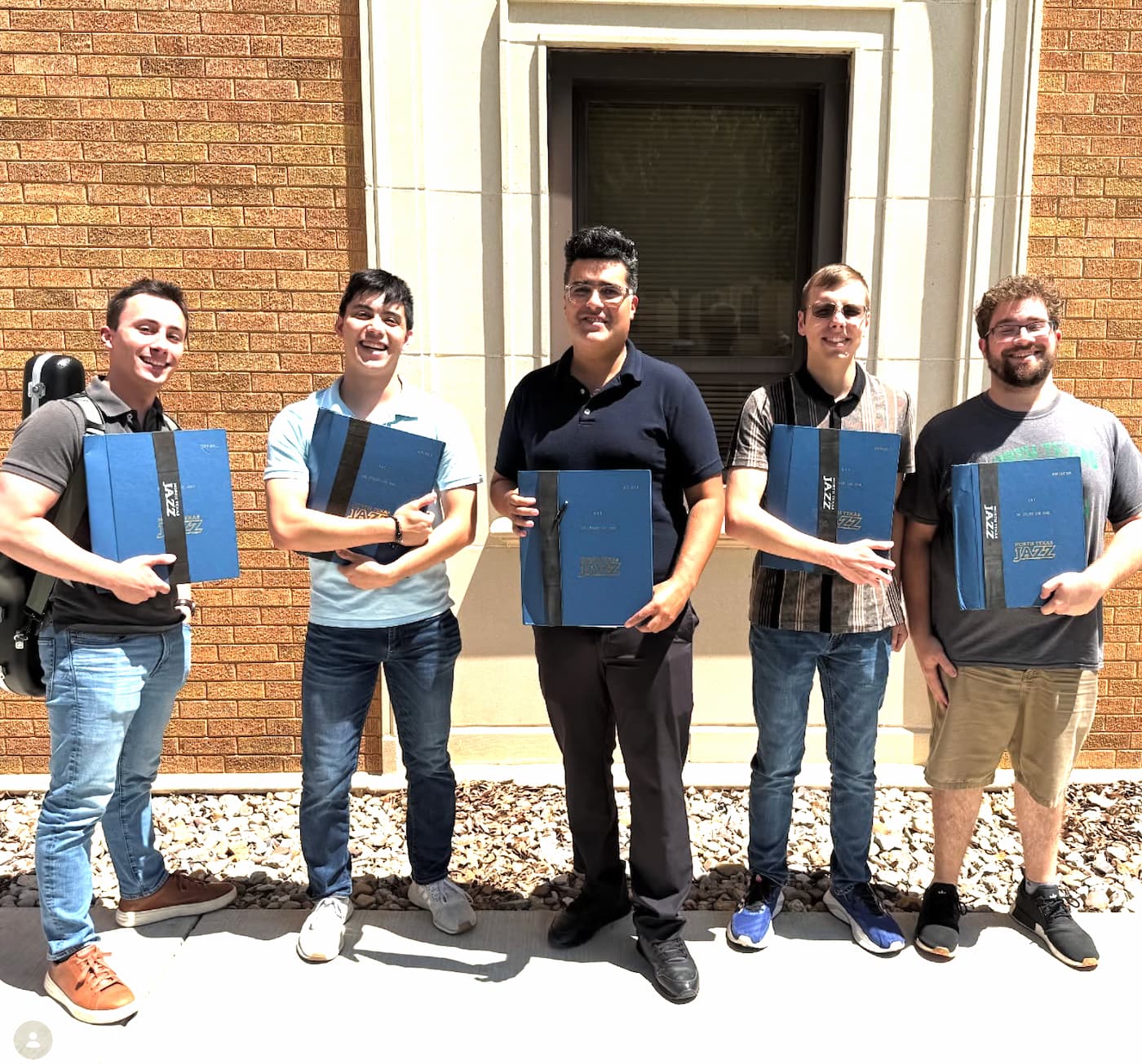 The five saxophonists of the One O'clock Band pose with their historic folders 