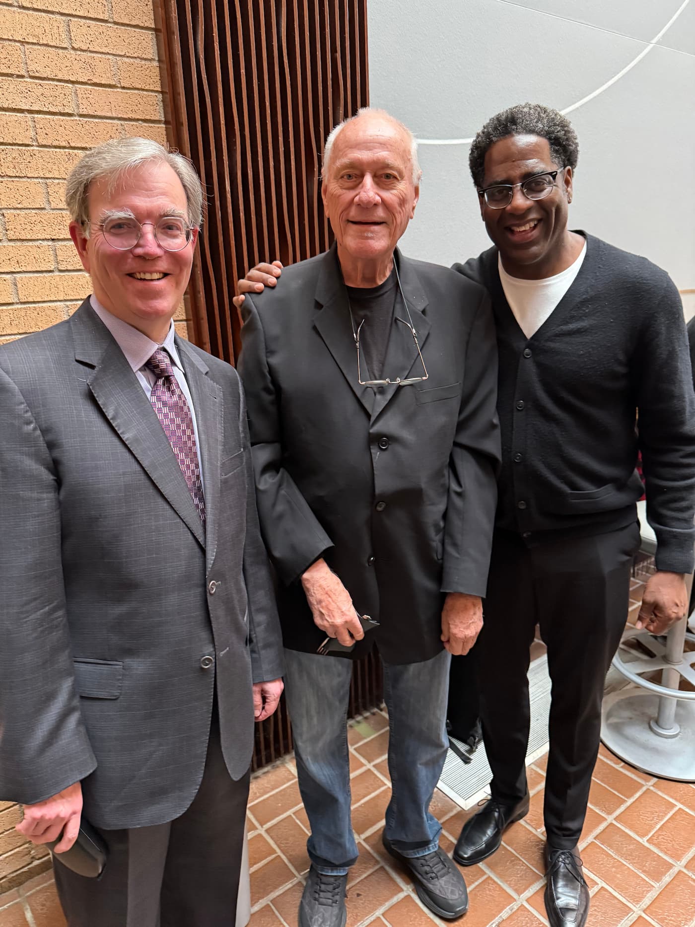 Eric Nestler, Jim Riggs, and Brad Leali pose for a celebratory photo