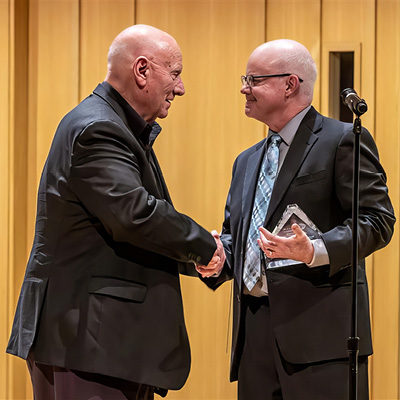 CBDNA Past-President Mark Spede, presented UNT Regents Professor of Music, Eugene Migliaro Corporon, with its Lifetime Achievement Award